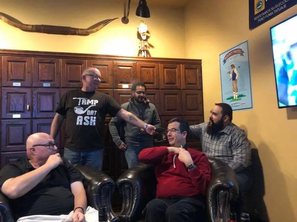Members talking and smoking by the locker wall